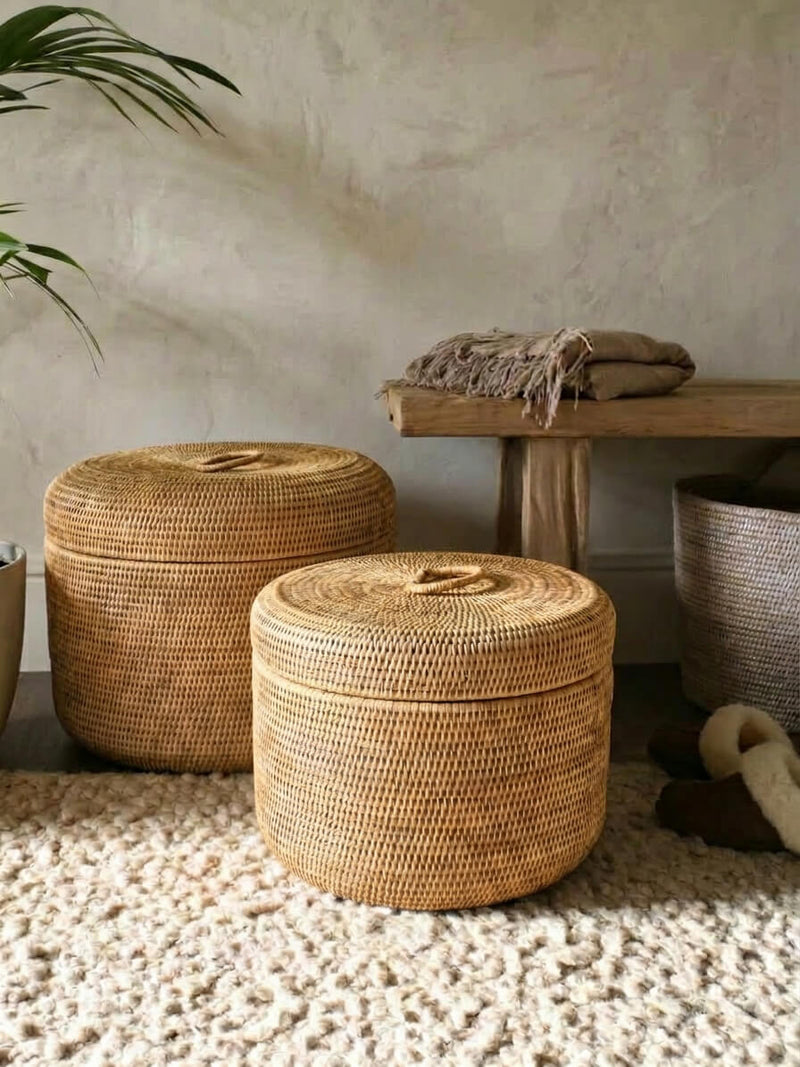 Ely natural round rattan storage boxes set in a neutral living space, handwoven wicker baskets for luxury home storage, blankets and soft furnishings