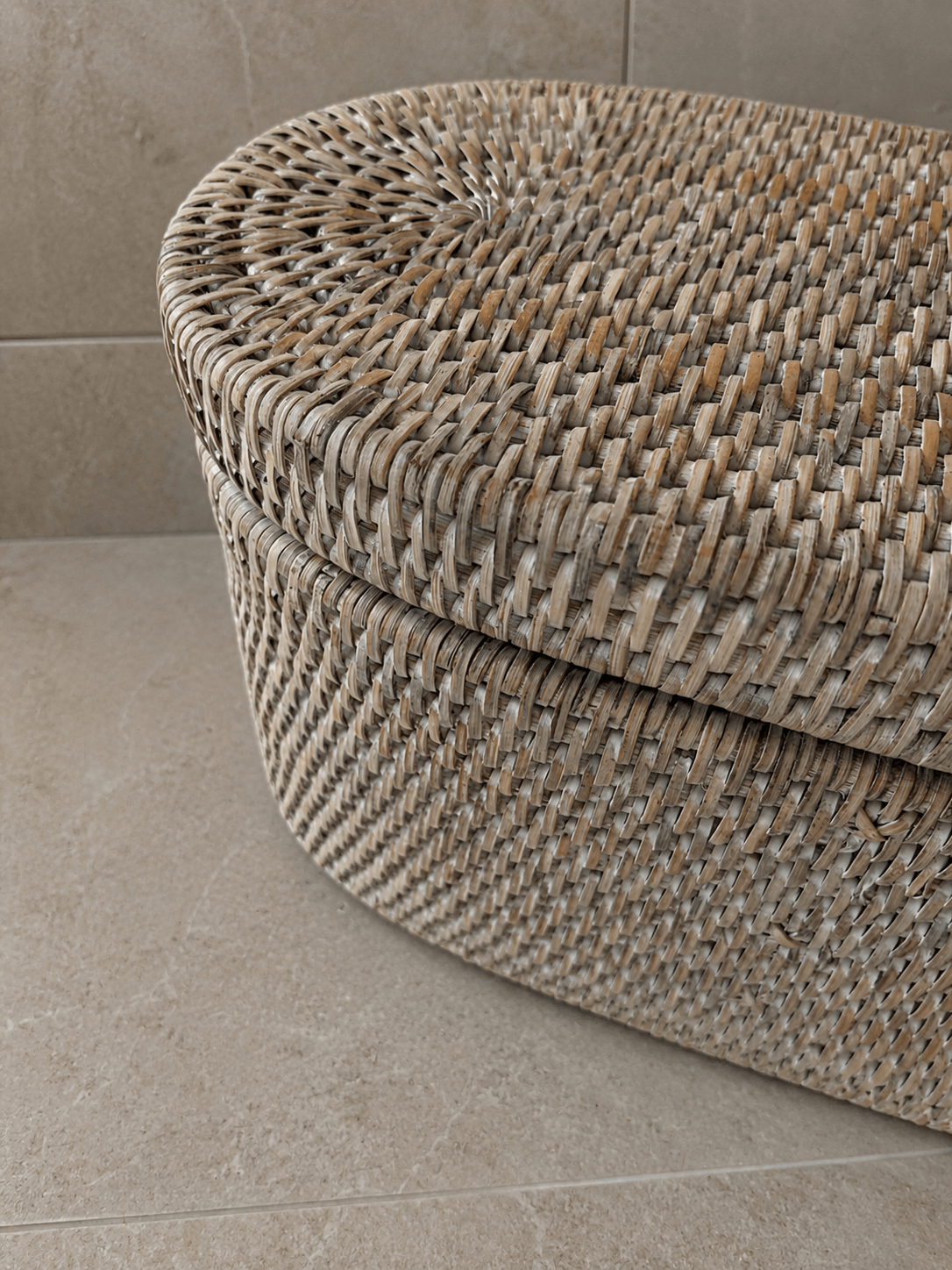 Jarra rattan lidded basket on a tiled floor