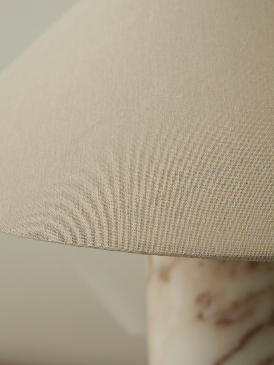 Close-up of a beige lampshade on a marble surface