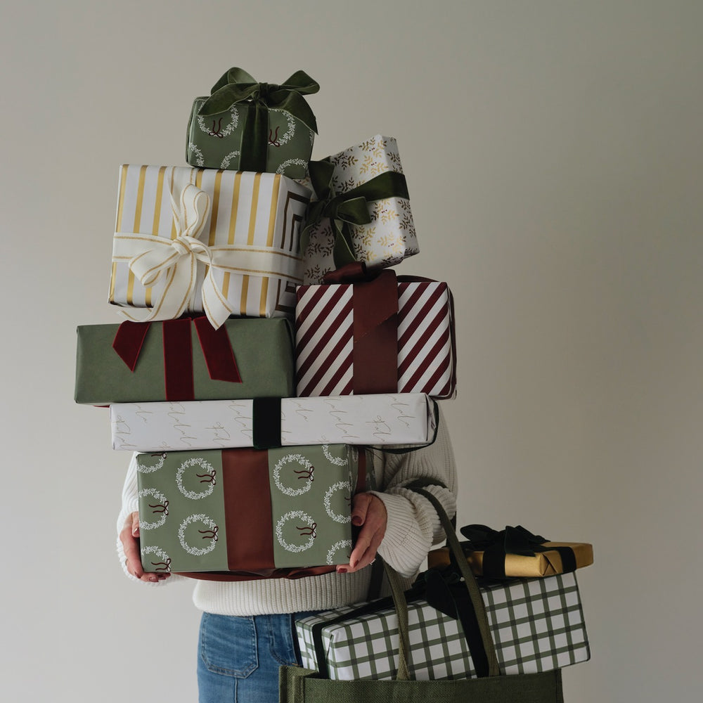Thoughtfully wrapped gifts in burgundy, green and gold