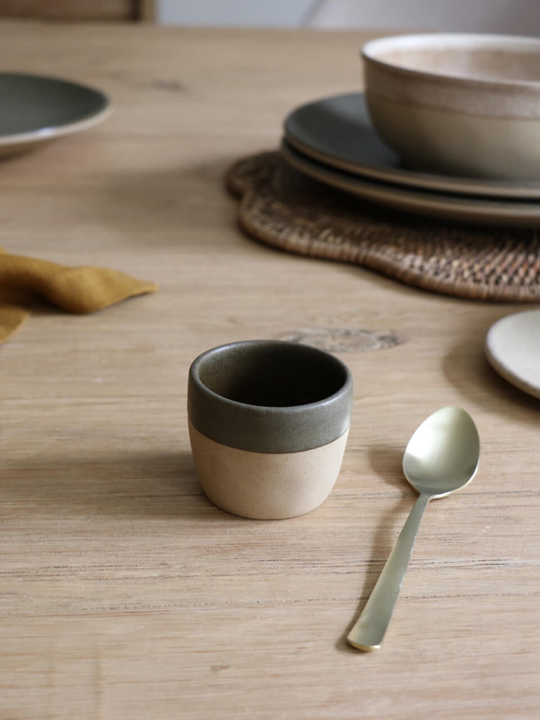 Ceramic Espresso cup  on reclaimed wooden table with soft golden teaspoon
