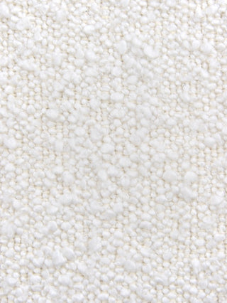 A close-up texture shot of a white or off-white plush, short-pile fabric or carpet with a soft, nubby surface.