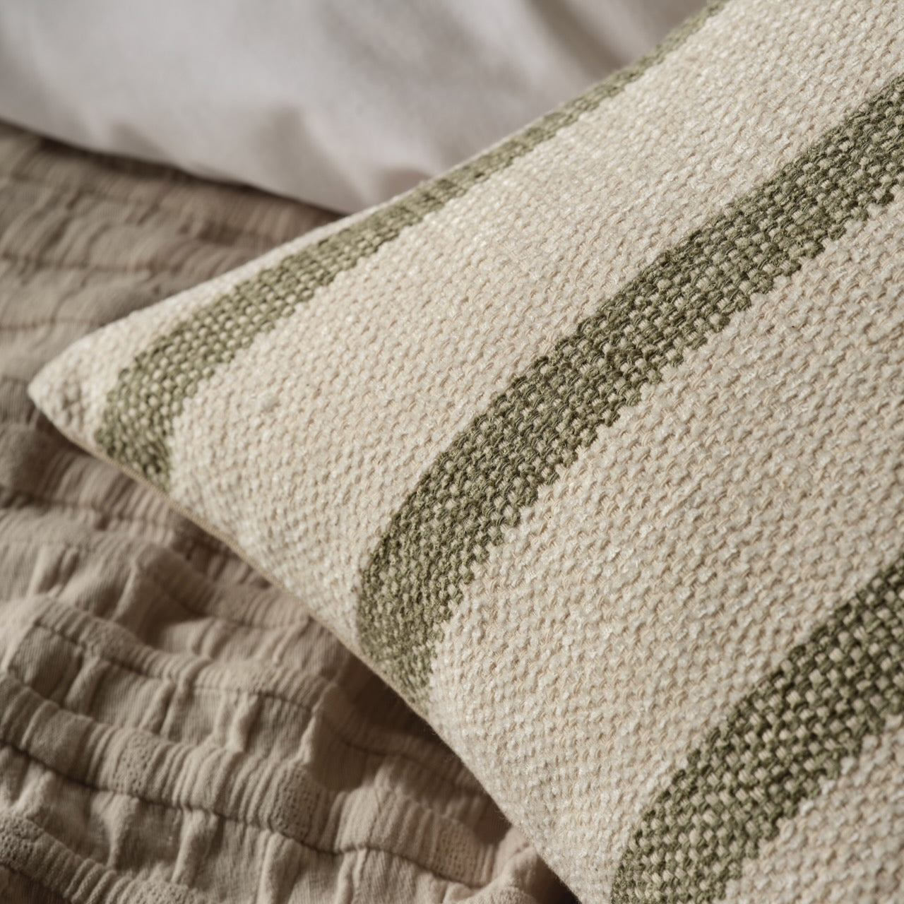 Detail of Cream & Green Stripe Cushion Cover by Layered Lounge which shows the lovely texture.