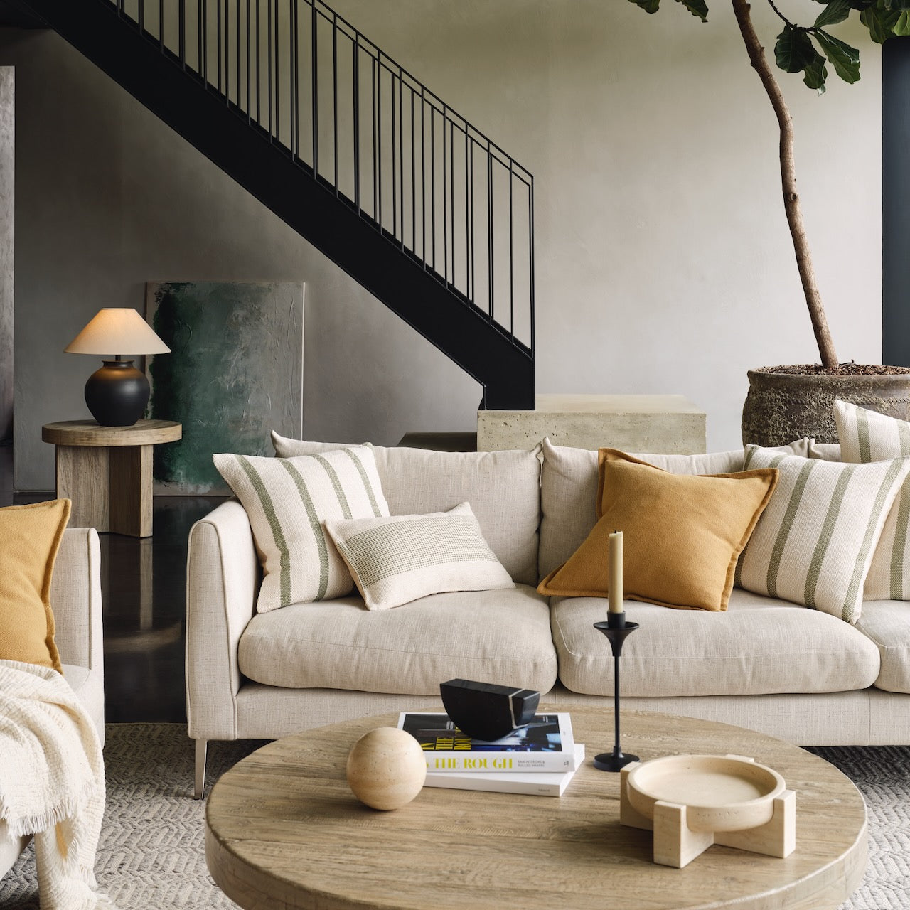 Living room styling by Layered Lounge with our collection of cushions and travertine pieces.