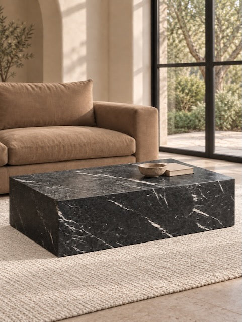 Marlborough Nero Marquina black leathered marble coffee table styled on a cream rug beside a caramel sofa in a warm, sunlit living room.
