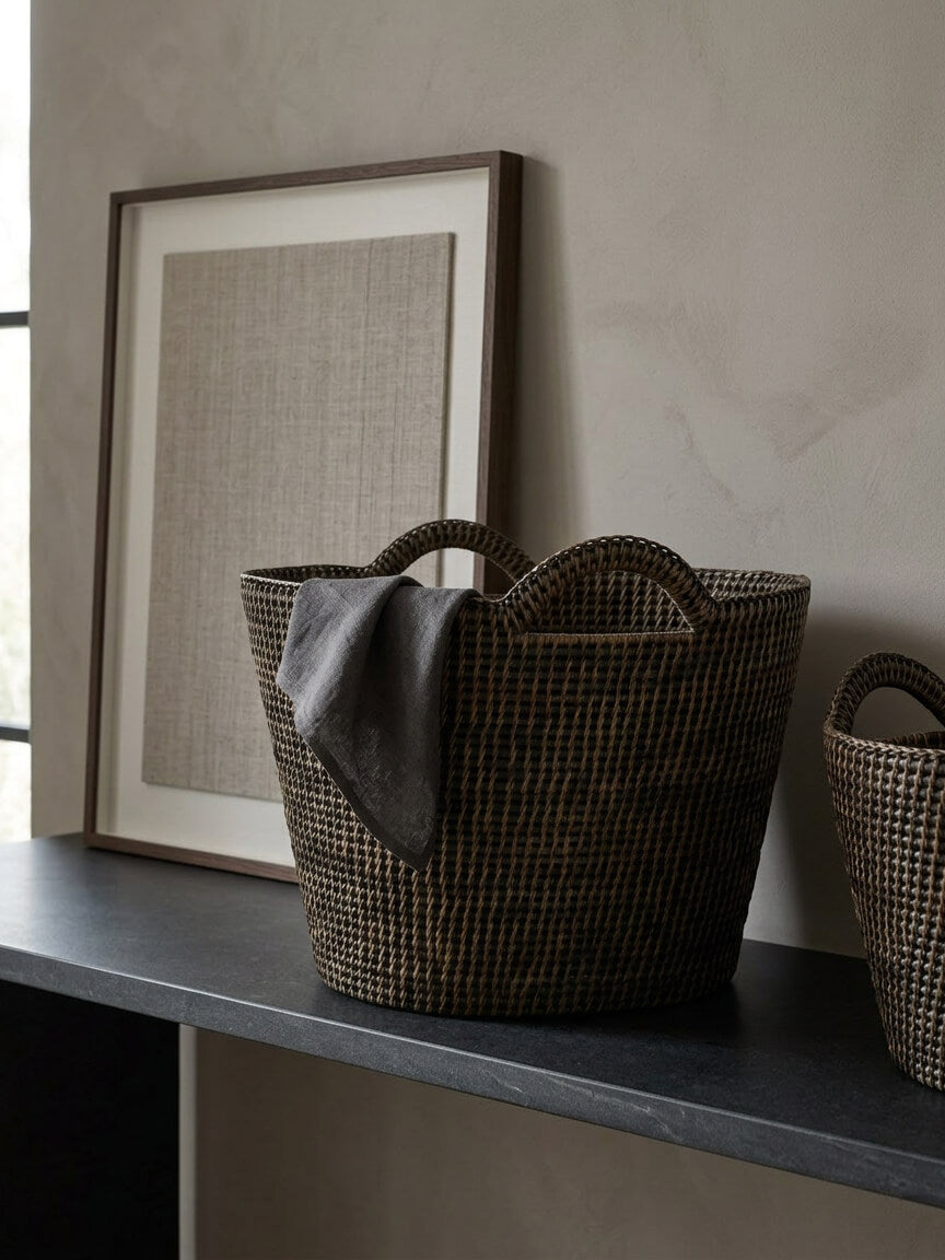 Nairn large brown rattan bucket basket styled on console with framed artwork in calm neutral interior