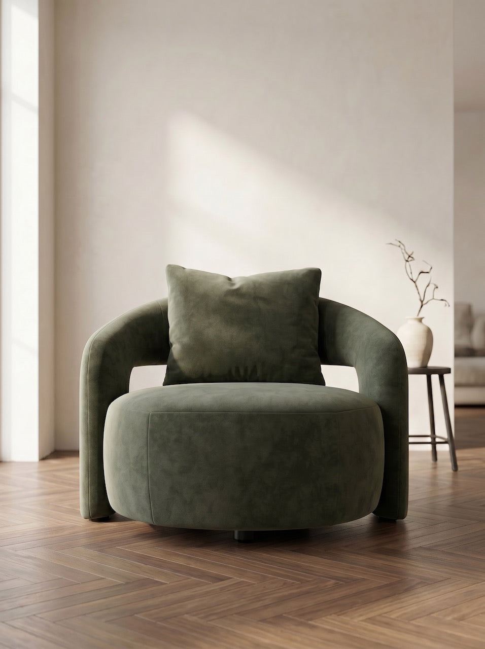 Green armchair with a cushion in a room with wooden flooring and a neutral wall.