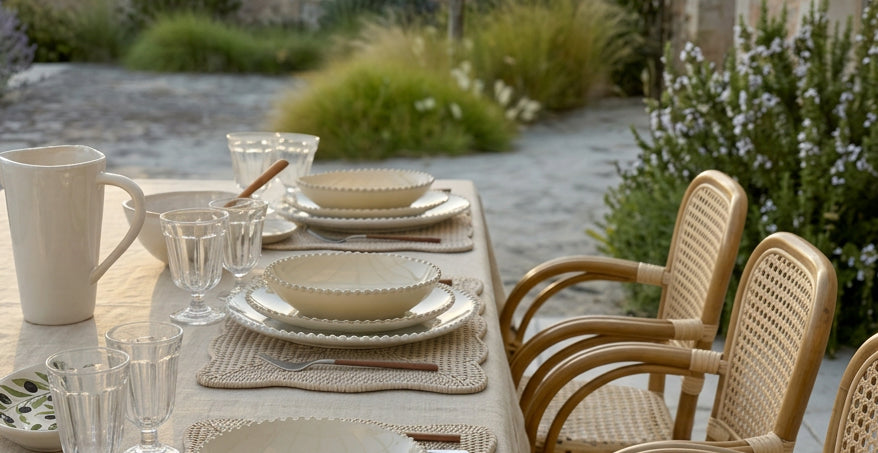 Pearl stoneware layered with woven placemats on a dining table